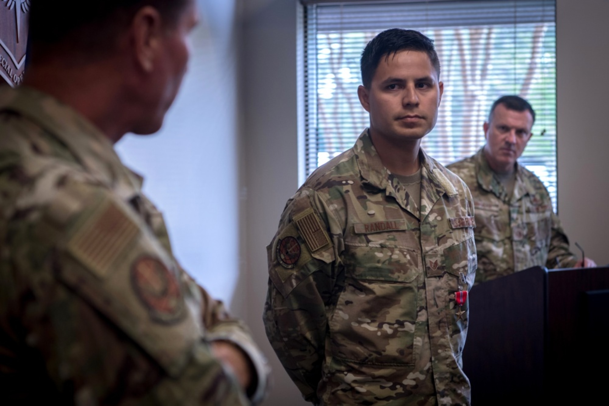 An airman, right, looks at his commander ,left, as he gives comments.