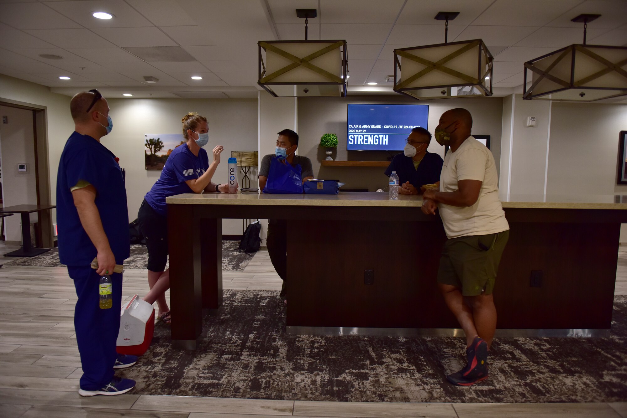 Airmen and Soldiers from the California National Guard decompress at the end of their shift in El Centro, California, May 29, 2020. The Guard medical team is augmenting staff at Pioneer Memorial Hospital in Brawley due to a surge in COVID-19 patients there.