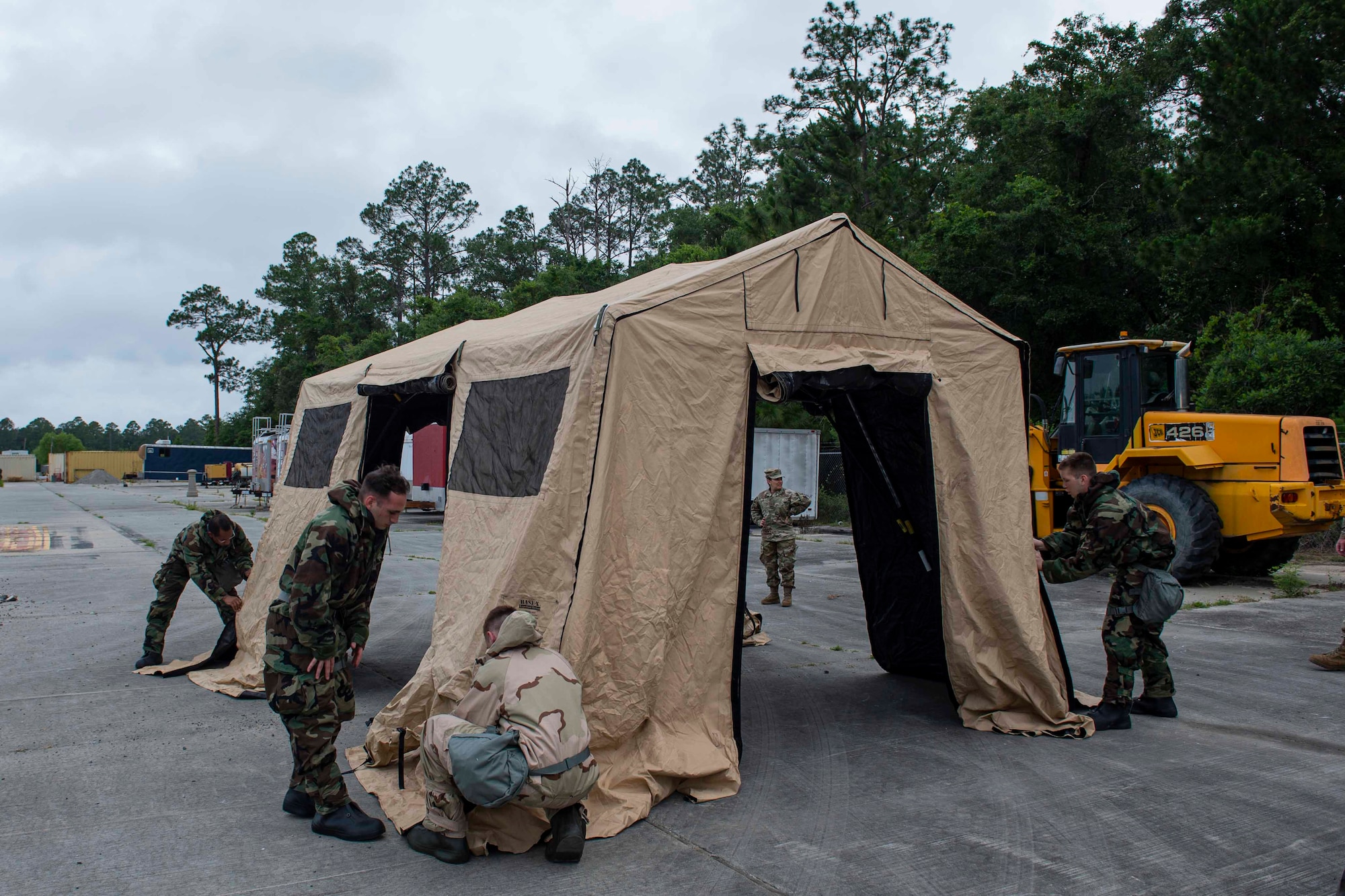 Photo of students of the Multi-Capable Airmen course setting up a tent.