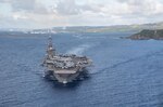 PHILIPPINE SEA (June 4, 2020) The aircraft carrier USS Theodore Roosevelt (CVN 71) departs Apra Harbor July 4, 2020. Following an extended visit to Guam in the midst of the COVID-19 global pandemic, Theodore Roosevelt is returning to operational tasking during a deployment to the Indo-Pacific.