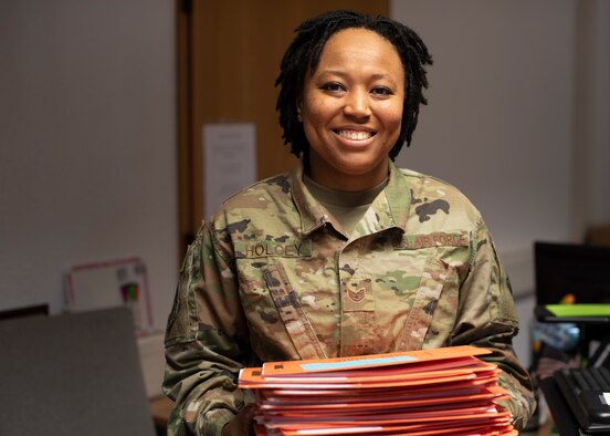 U.S. Air Force Staff Sgt. Jasmine Holcey, 786th Force Support Squadron relocations supervisor, poses for a photo in the base relocations office at Ramstein Air Base, Germany, June 1, 2020.