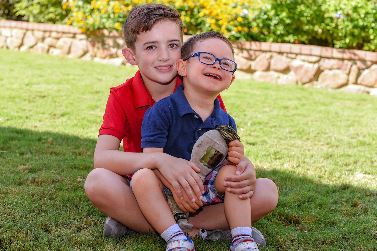Two boys pose for a photo.
