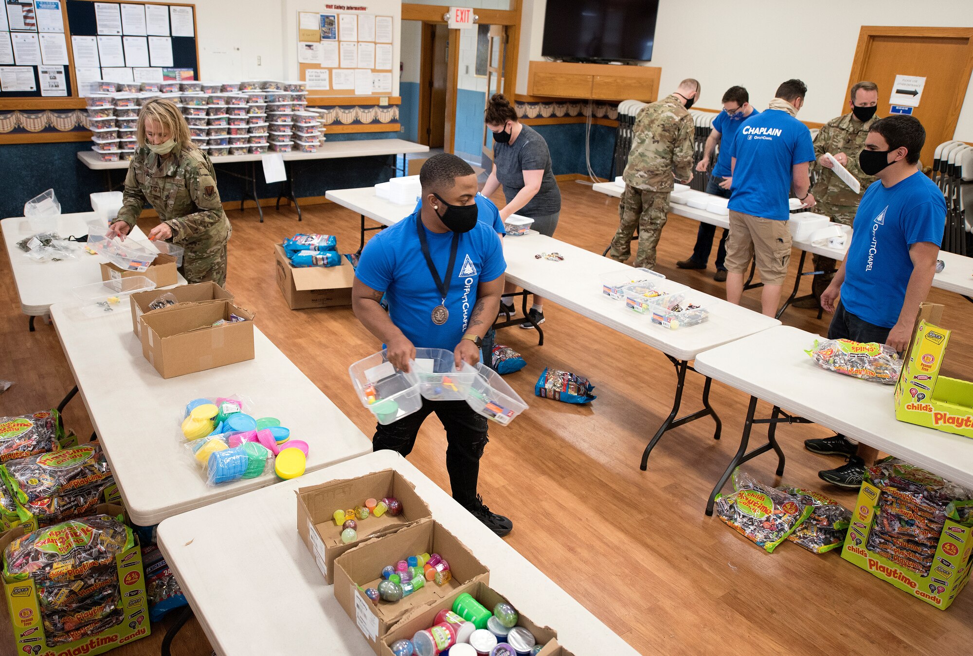 service members fill containers and stack them.