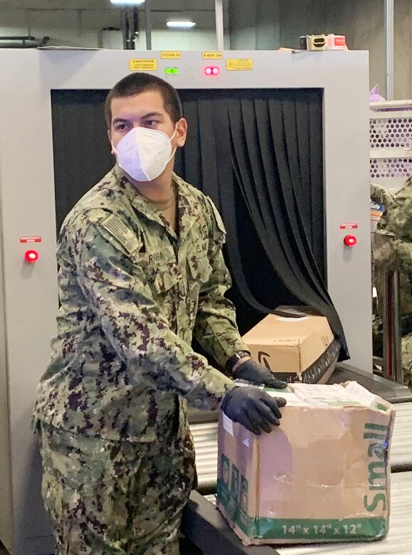 Sailors handling mail at the San Diego Regional Navy Mail Center.