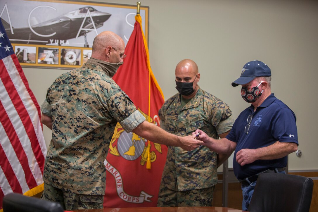 U.S. Marine Corps Maj. Craig Sisson with Marine Corps Air Station (MCAS) Yuma, receives a Purple Heart from Col. David A. Suggs, commanding officer, MCAS Yuma, at the MCAS Yuma Headquarters building, June 1, 2020.