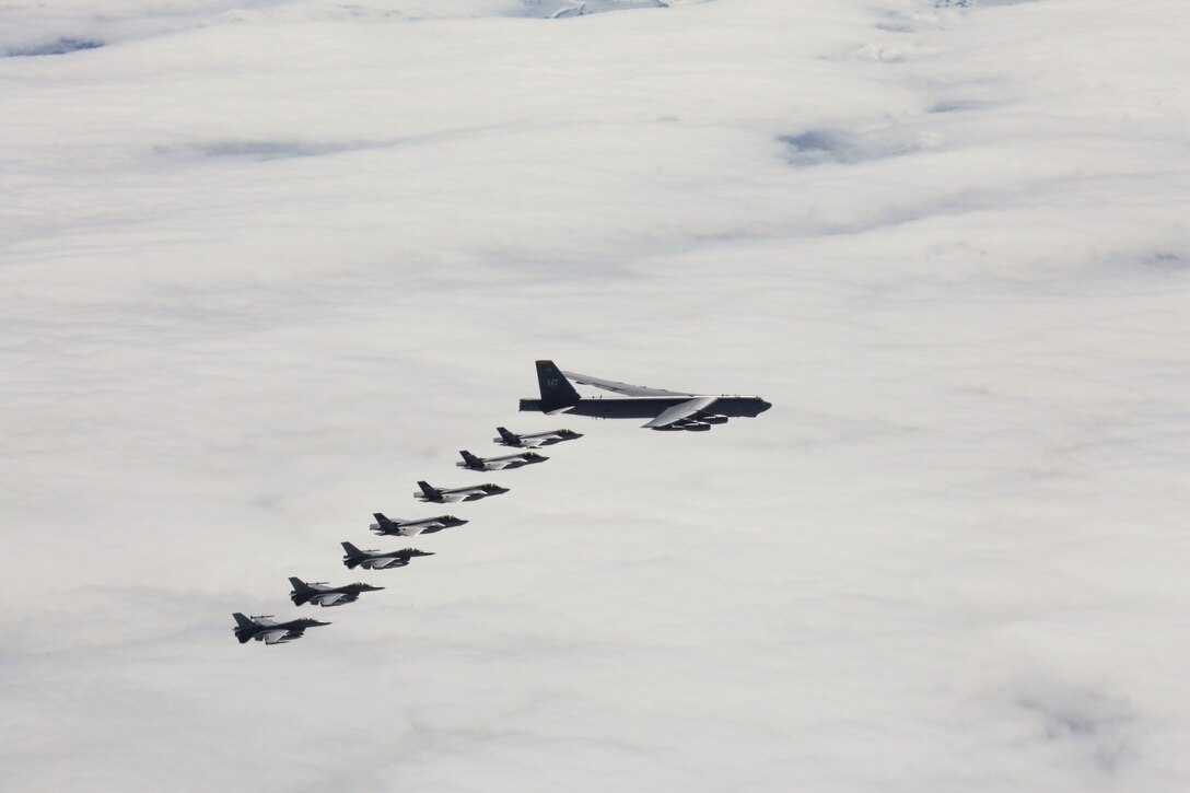 A U.S. Air Force aircraft and Norwegian air force aircraft fly near one another.
