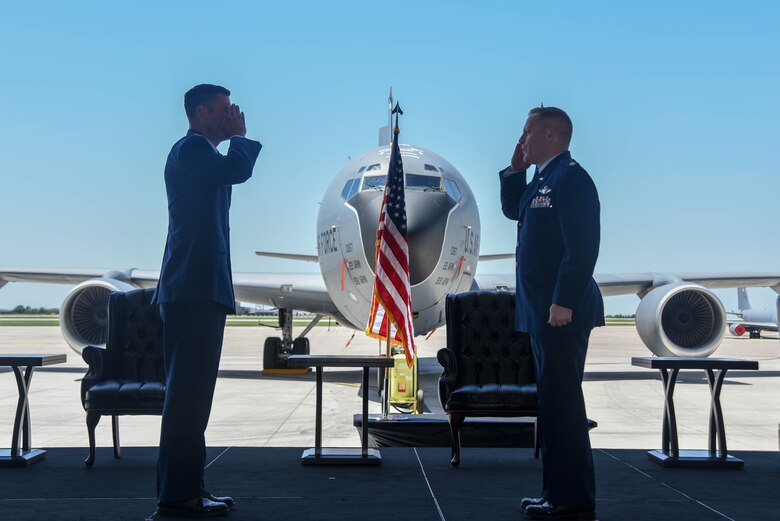 Lt. Col. Kevin White, 350th Air Refueling Squadron outgoing commander, right, relinquishes command during a change of command ceremony May 29, 2020, at McConnell Air Force Base, Kansas. White served as the 350th ARS commander for two years and will continue to serve at Scott Air Force Base, Illinois as a KC-46 Pegasus program manager. (U.S. Air Force photo by Airman 1st Class Marc A. Garcia)