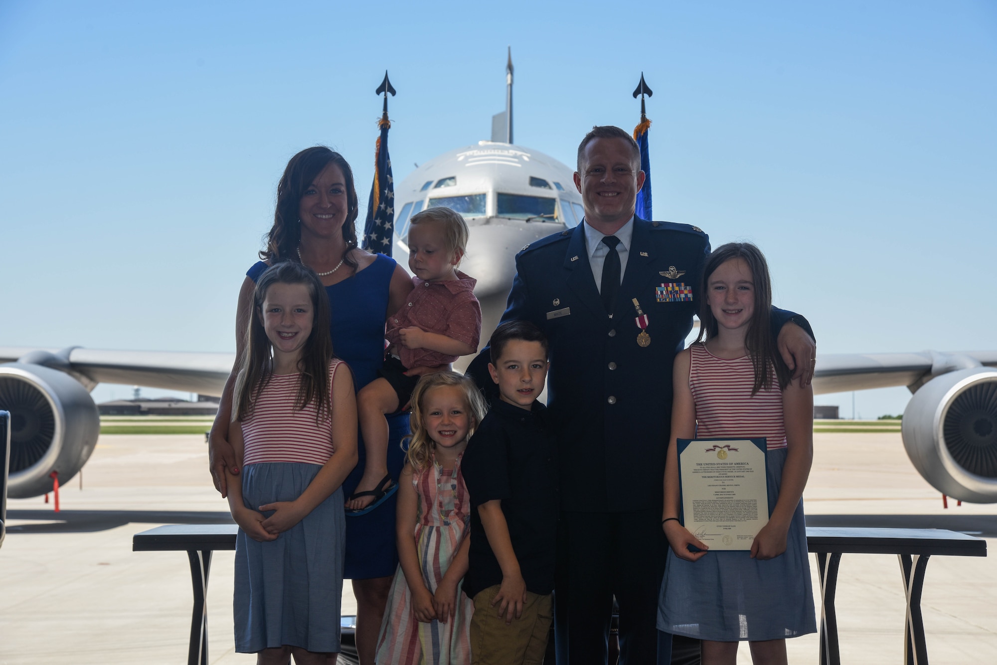 The White family presents the Meritorious Service Medal citation to Lt. Col. Kevin White, 350th Air Refueling Squadron outgoing commander, during a change of command ceremony May 29, 2020, at McConnell Air Force Base, Kansas. The Meritorious Service Medal is awarded to members of the U.S. Armed Forces who distinguished themselves by outstanding noncombat meritorious achievement or service. (U.S. Air Force photo by Airman 1st Class Marc A. Garcia)
