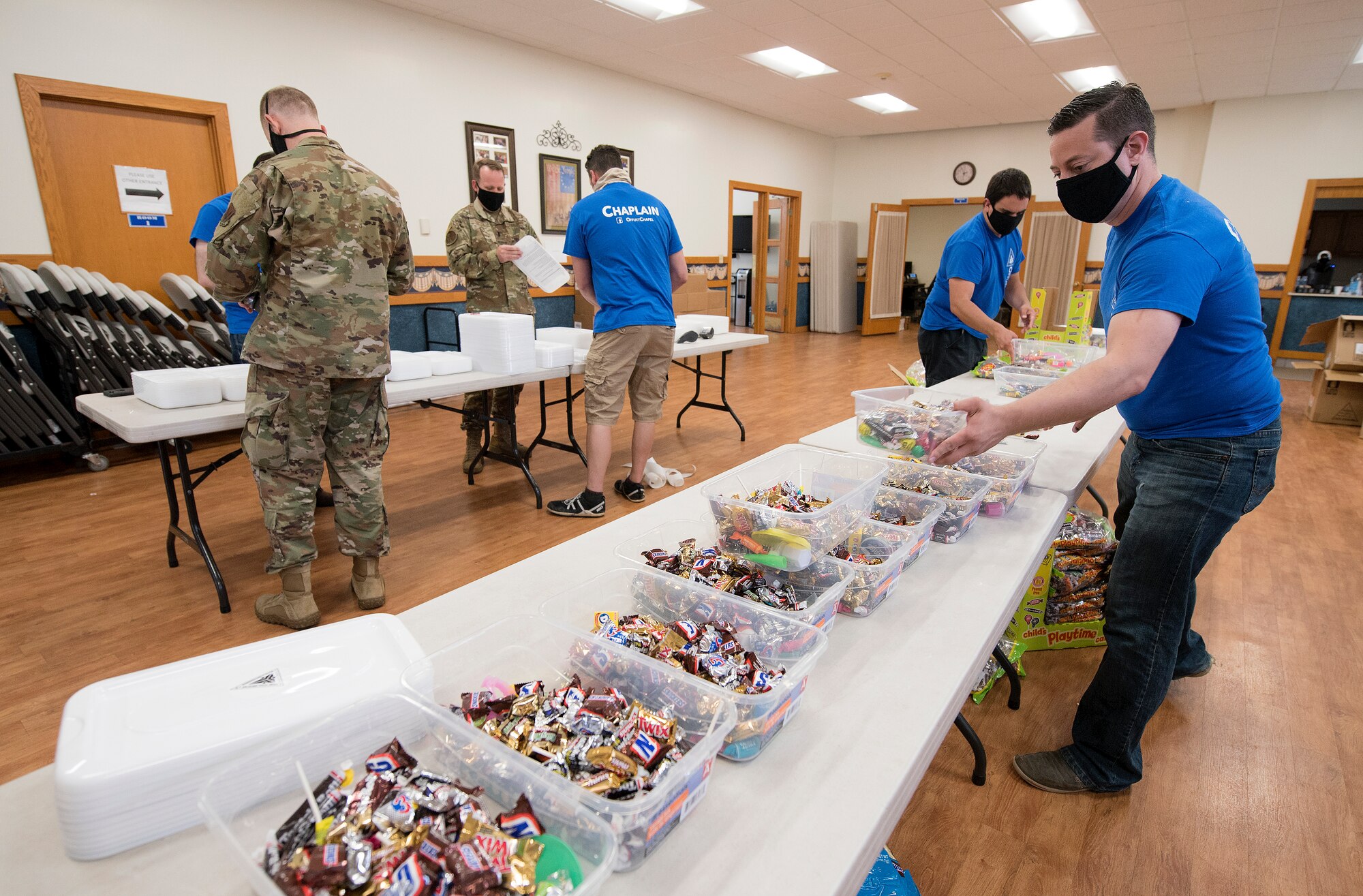 service members fill containers with candy, knickknacks and toys