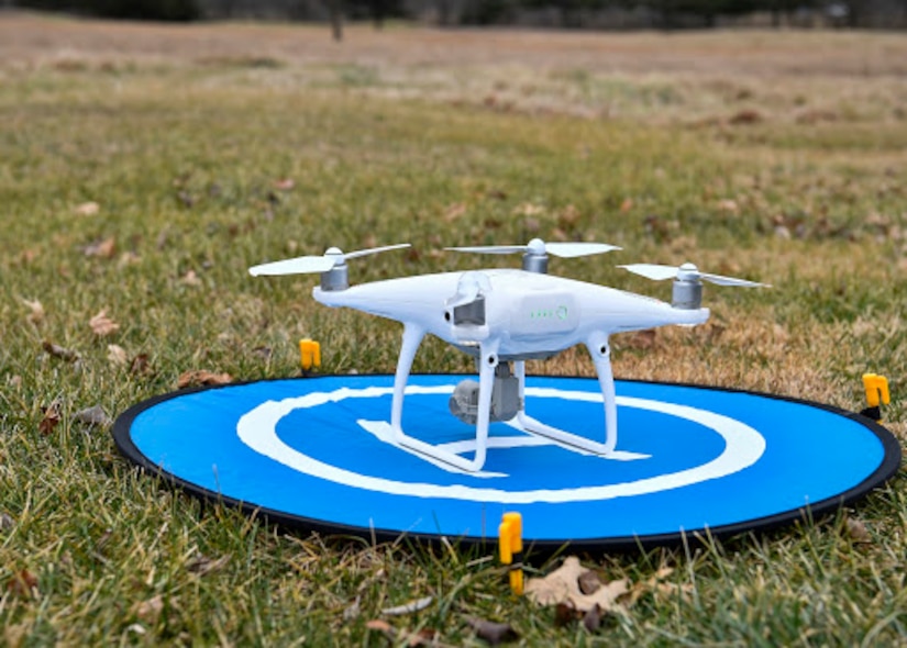 A photo of a drone sitting on a landing spot.