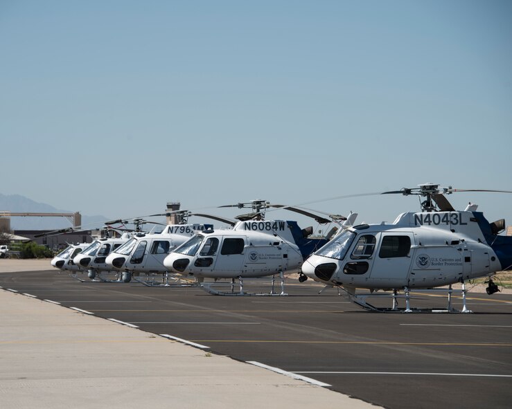 A photo of a CBP helicopter sitting on the flight line.