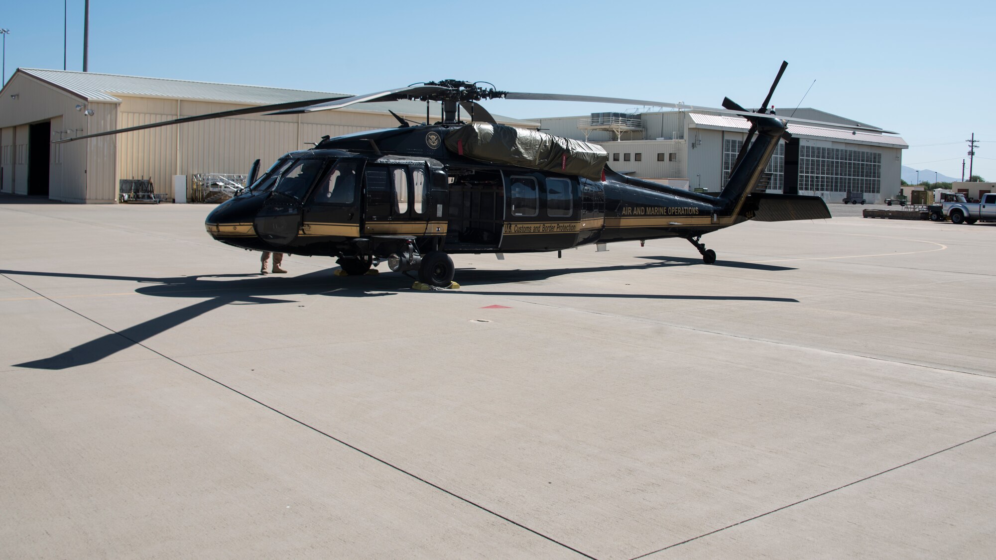 A photo of a CPB helicopter sitting on the flight line.