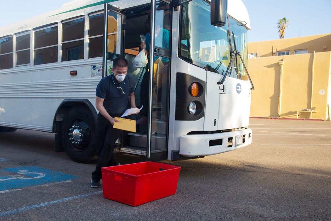 New recruits with Mike Company, 3rd Recruit training Battalion, arrive at Marine Corps Recruit Depot, San Diego, May 26, 2020.
