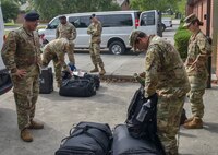 Members of Joint Base Charleston check their bags before loading them into a van for a deployment at JB Charleston S.C., May 31, 2020. Deployments are necessary for military members in order to ensure rapid global mobility for whenever an operation is needed to be carried out; furthermore, deployments are an opportunity for military members to expand their knowledge and work in different environments.