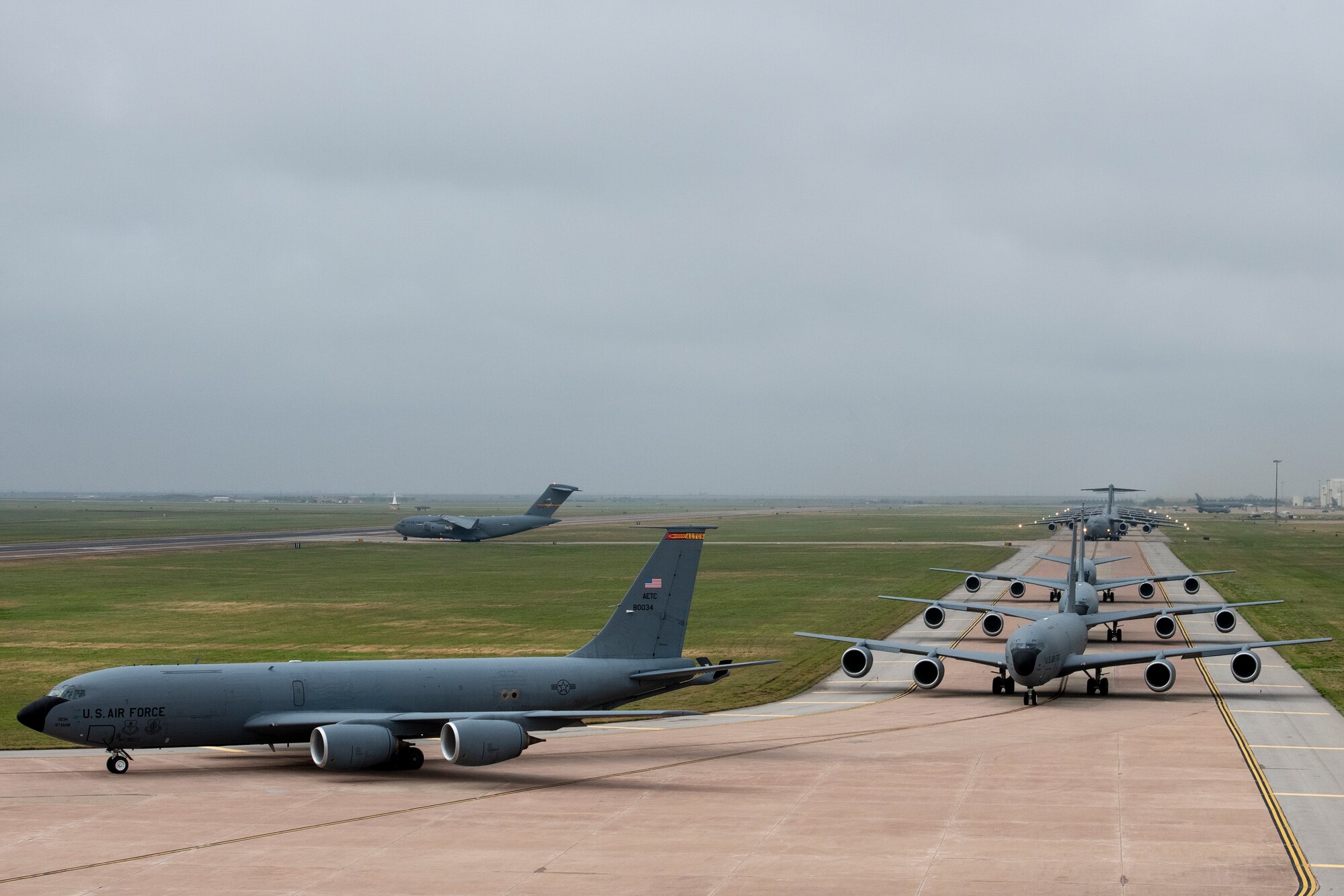 U.S. Air Force KC-135 Stratotankers, C-17 Globemaster IIIs and KC-46 Pegasus aircraft taxi to the runway at Altus Air Force Base, Oklahoma, during a large formation exercise, May 21, 2020.