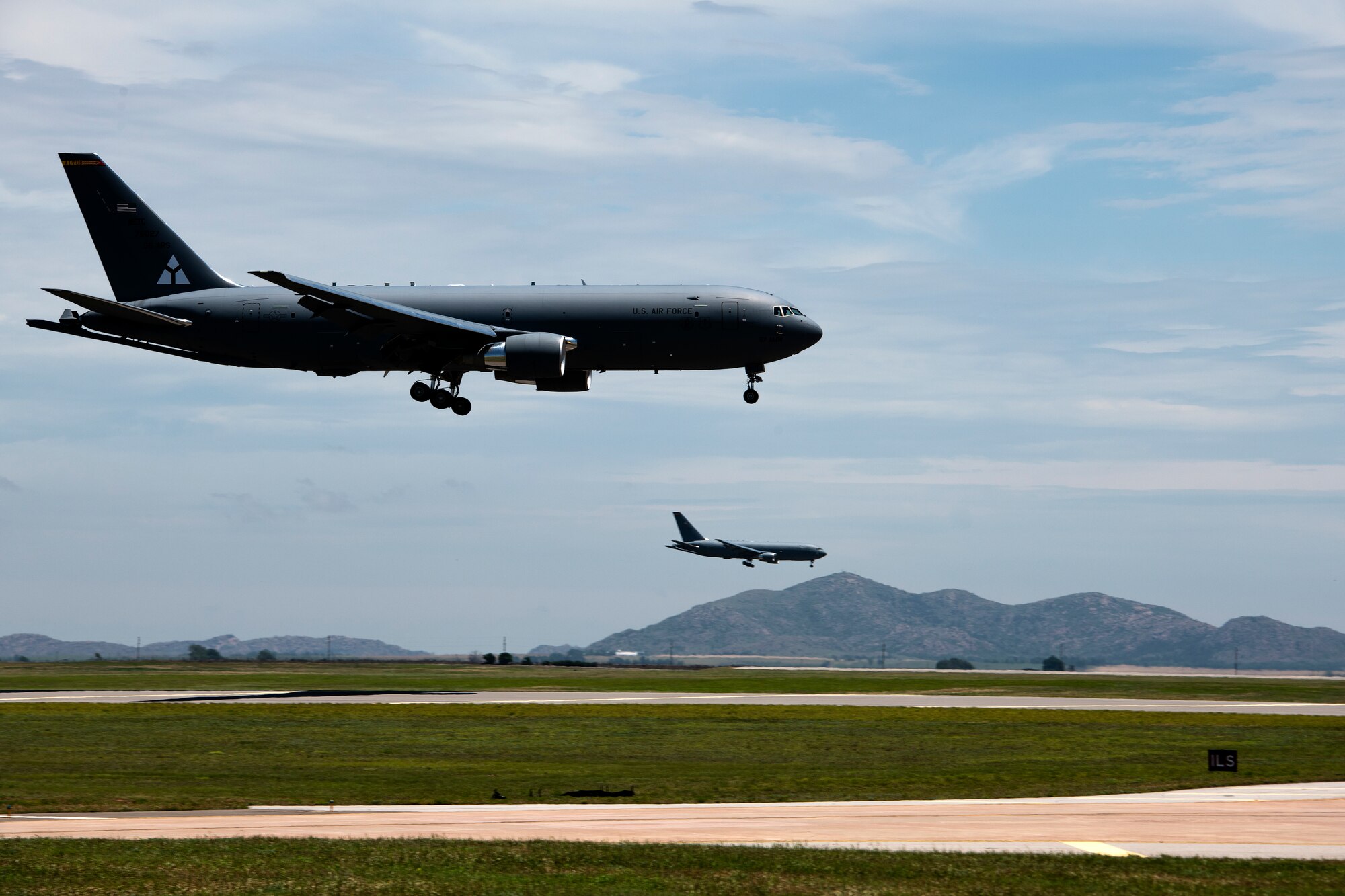 U.S. Air Force KC-46 Pegasus aircraft land on the runway at Altus Air Force Base, Oklahoma, during a large formation exercise, May 21, 2020.