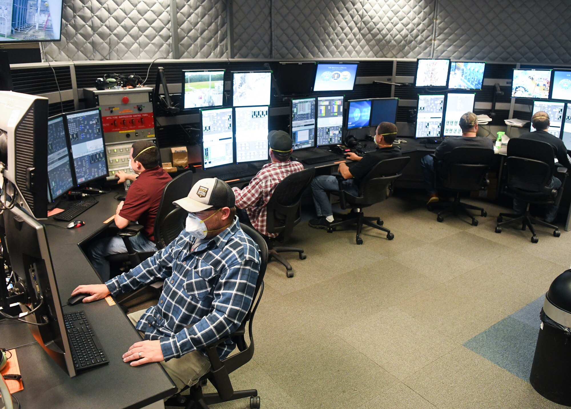 Joseph Cowan, left, an outside machinist, and other Team AEDC personnel work in the control room of the Arnold Engineering Development Complex (AEDC) Aerodynamic and Propulsion Test Unit (APTU), May 20, 2020, while wearing masks to help mitigate risk associated with the coronavirus pandemic. The APTU team has performed their tasks, providing hypersonic testing capabilities, without interruption during the pandemic. Hypersonics is considered a critical field for national defense. (U.S. Air Force photo by Jill Pickett)