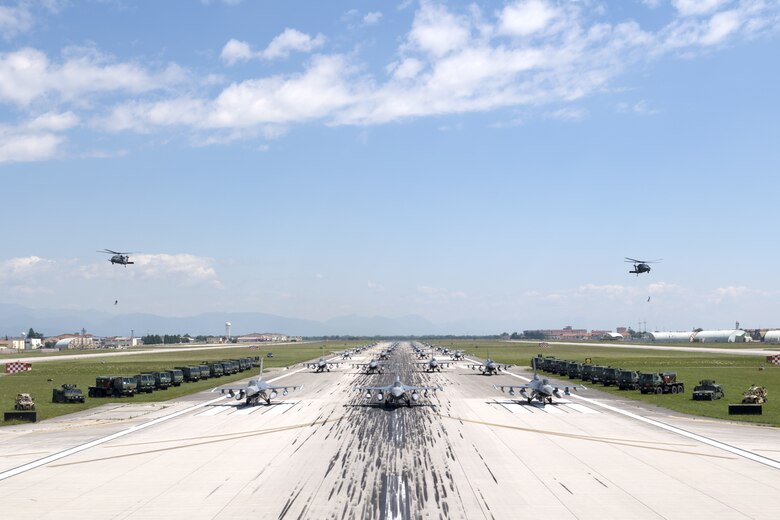 U.S. Air Force aircraft and vehicles assigned to the 31st Fighter Wing line the runway during an elephant walk at Aviano Air Base, Italy, June 1, 2020. Squadrons represented include the 555th and 510th Fighter Squadrons, 56th and 57th Rescue Squadrons, the 606th Air Control Squadron, and the 31st Security Forces Squadron. (U.S. Air Force photo by Staff Sgt. Kelsey Tucker)