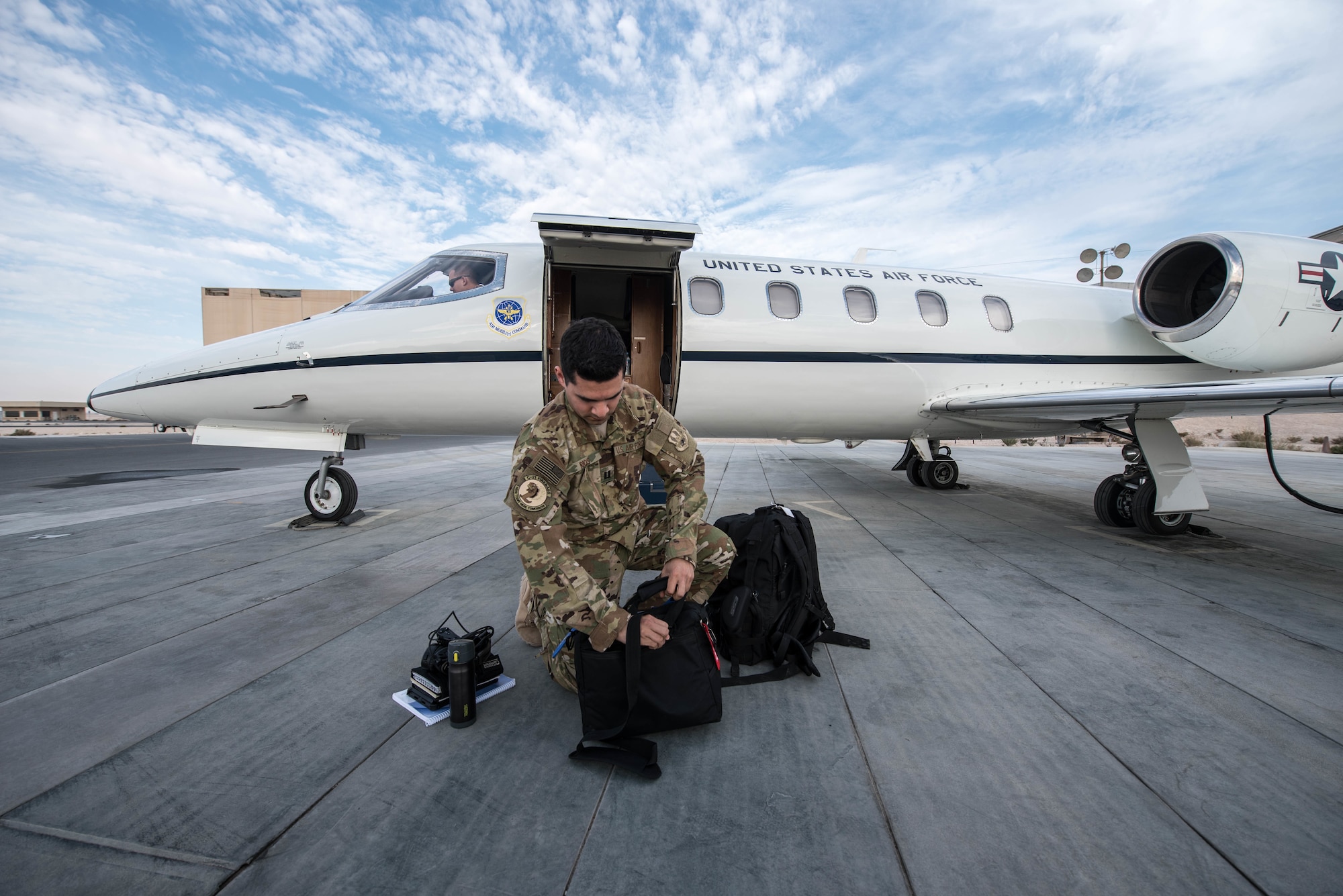 U.S. Air Force Capt. Ramiro Rios,  a C-21 pilot assigned to the 746th Expeditionary Airlift Squadron, prepares for a flight at Al Udeid Air Base, Qatar, Feb. 7, 2018.  (U.S. Air National Guard photo by Master Sgt. Phil Speck)