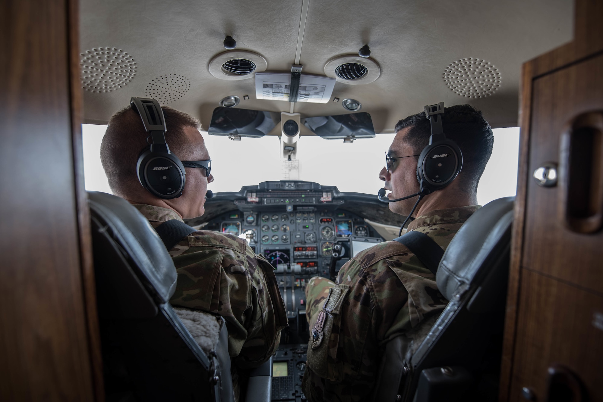U.S. Air Force 1st Lt. Riley Snowden (left) and Capt. Ramiro Rios, C-21 pilots assigned to the 746th Expeditionary Airlift Squadron, fly a mission over the Middle East, Feb. 7, 2018. (U.S. Air National Guard photo by Master Sgt. Phil Speck)