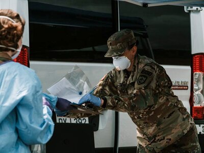 A West Virginia Army National Guard Soldier assists with COVID-19 testing preparation June 1, 2020, at the Mountaineer ChalleNGe Academy at Camp Dawson in Kingwood, W.Va. The Mountaineer ChalleNGe Academy was closed in March to in-person classes due to the COVID-19 pandemic but WVNG and MCA staff developed plans to ensure cadets could complete the program.