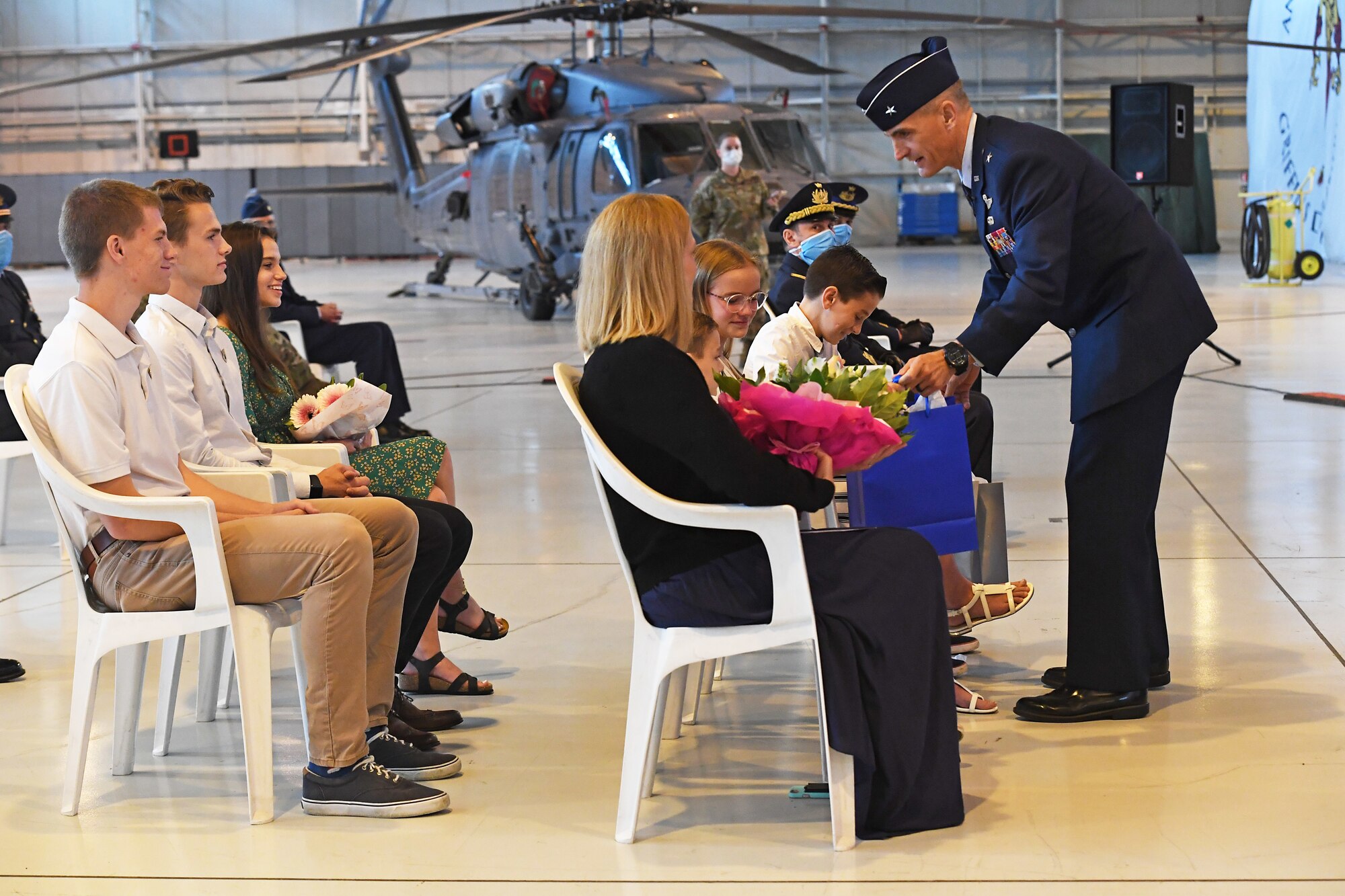 U.S. Air Force Brig. Gen. Daniel T. Lasica, 31st Fighter Wing outgoing commander, presents his family with flowers and gifts during a change of command ceremony at Aviano Air Base, Italy, June 5, 2020. U.S. Air Force Brig. Gen. Daniel T. Lasica led 4,500 airmen supporting operations across three combatant commands from June 17, 2018 to June 5, 2020. (U.S. Air Force photo by Staff Sgt. Valerie Halbert)