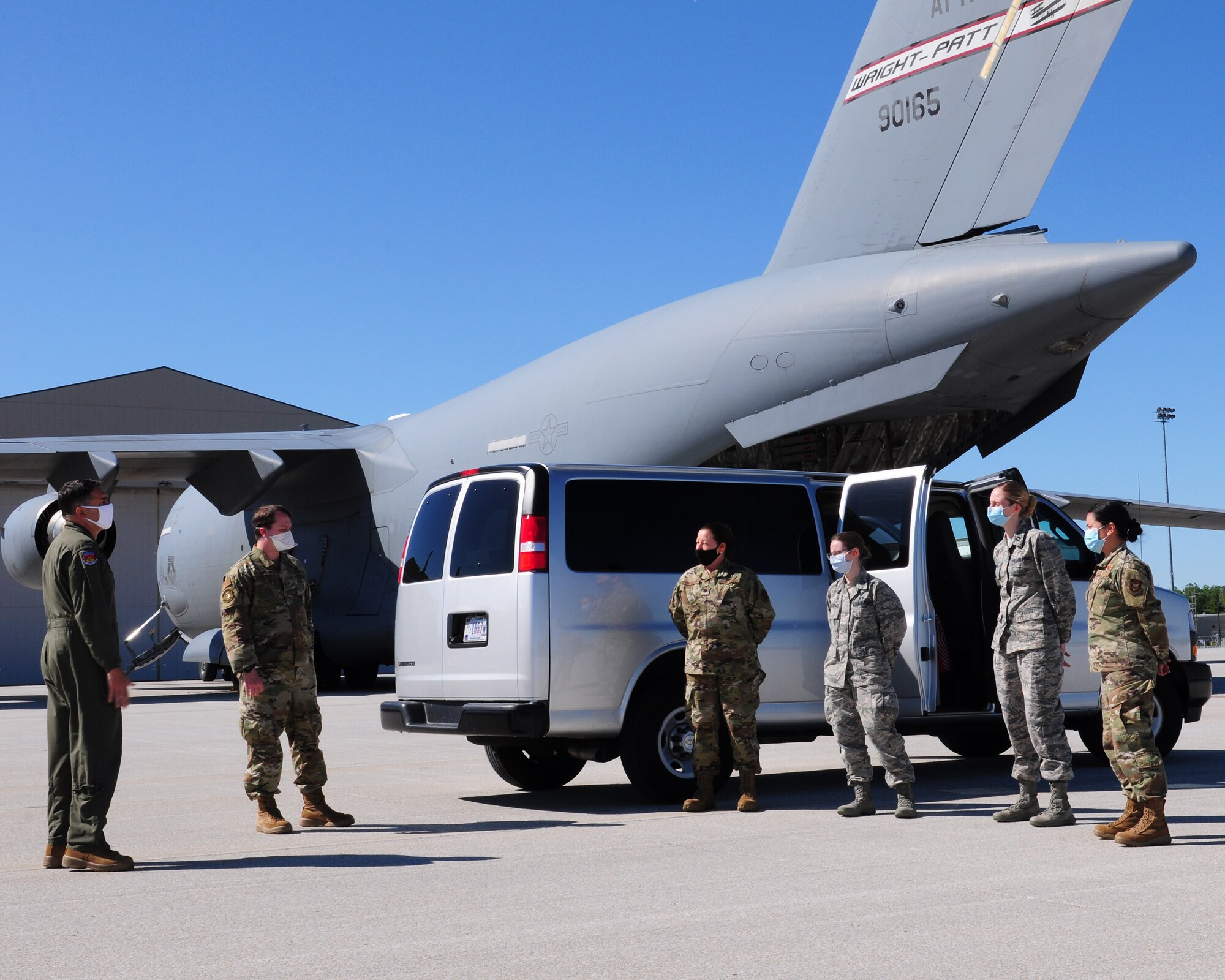 Col. Raymond Smith, Jr., 445th Airlift Wing commander, greets Airmen from the 445th Aeromedical Staging Squadron as they return from deployment May 31, 2020, at Wright-Patterson Air Force Base, Ohio. The medical reservists departed to serve on the front line of COVID-19 in New York City, New York in early April, 2020. The group partnered with civilian and military counterparts to support the Lincoln Medical Center in The Bronx, New York during the pandemic. (U.S. Air Force photo/Airman 1st Class Erin Zimpfer)