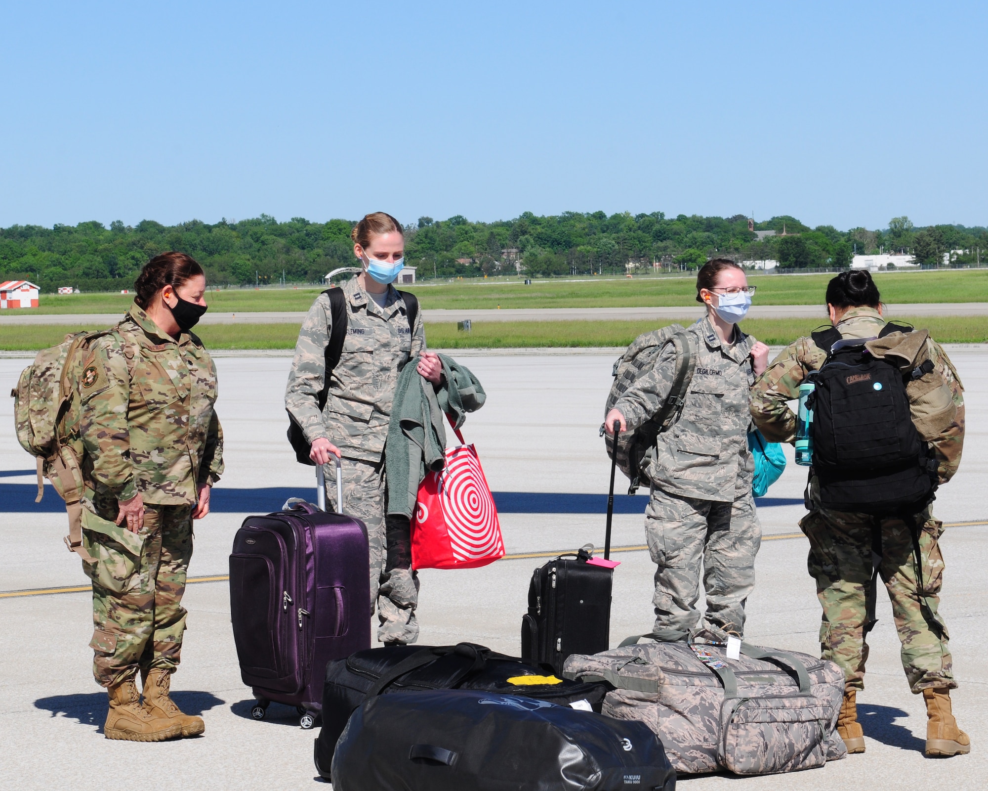Airmen from the 445th Aeromedical Staging Squadron return home here May 31, 2020, after arriving on a 445th Airlift Wing C-17 Globemaster III. The medical reservists departed to serve on the front line of COVID-19 in New York City, New York in early April, 2020. The group partnered with civilian and military counterparts to support the Lincoln Medical Center in The Bronx, New York during the pandemic. (U.S. Air Force photo/Airman 1st Class Erin Zimpfer)