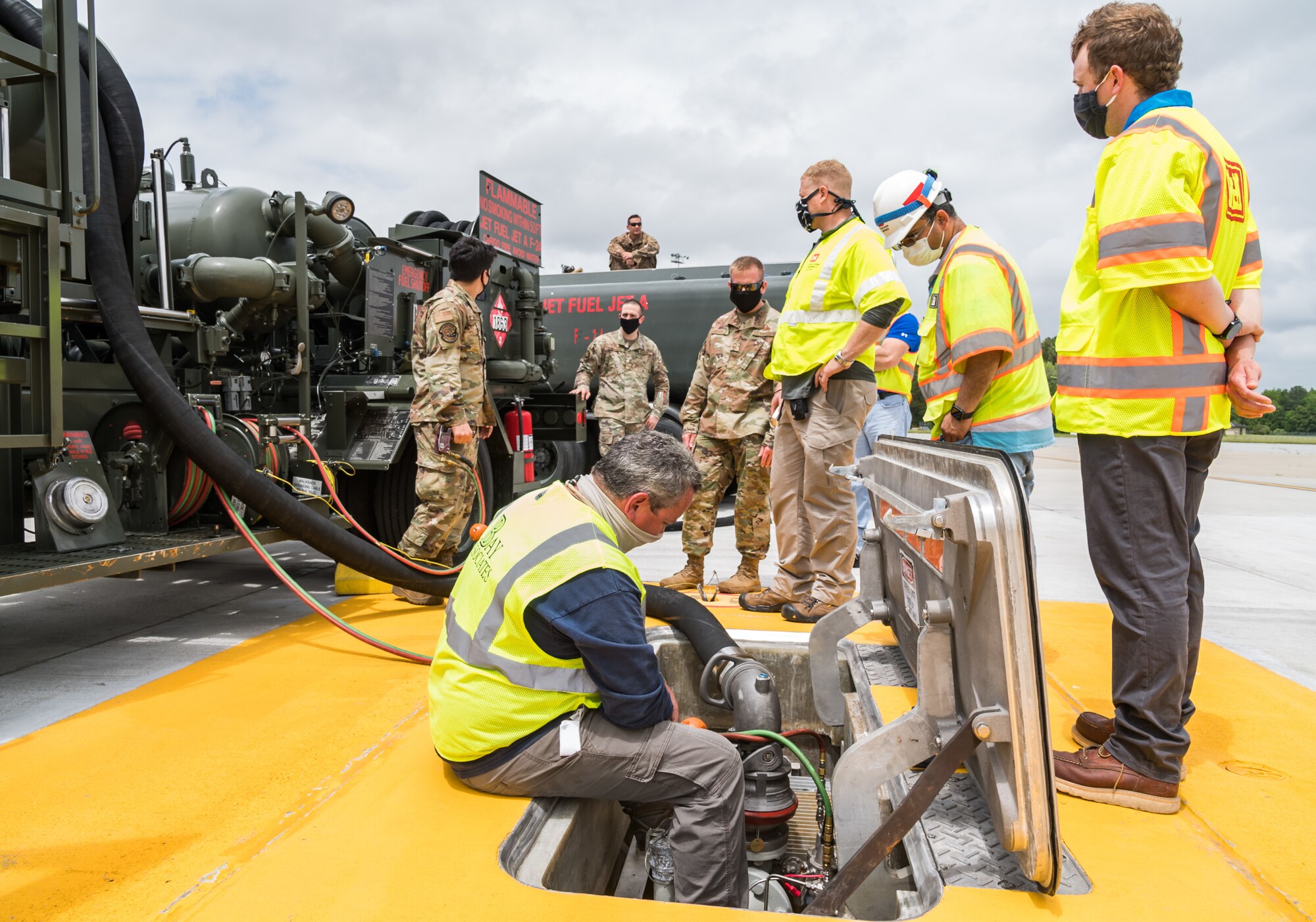 Personnel from the U.S. Army Corps of Engineers, Omaha and Philadelphia Districts; Bay Associates, Virginia Beach, Virginia; Structural Associates Inc.,  Syracuse, New York and 436th Civil Engineer Squadron monitor fuel flow and pressures during operational testing of the new fuel hydrant system located at the aircraft hot cargo area May 28, 2020, on Dover Air Force Base, Delaware. During fuel hydrant system testing, the R-12 pumped Jet-A fuel from the fuel pit to an R-11 fuel truck, which was used to simulate a receiver aircraft. (U.S. Air Force photo by Roland Balik)