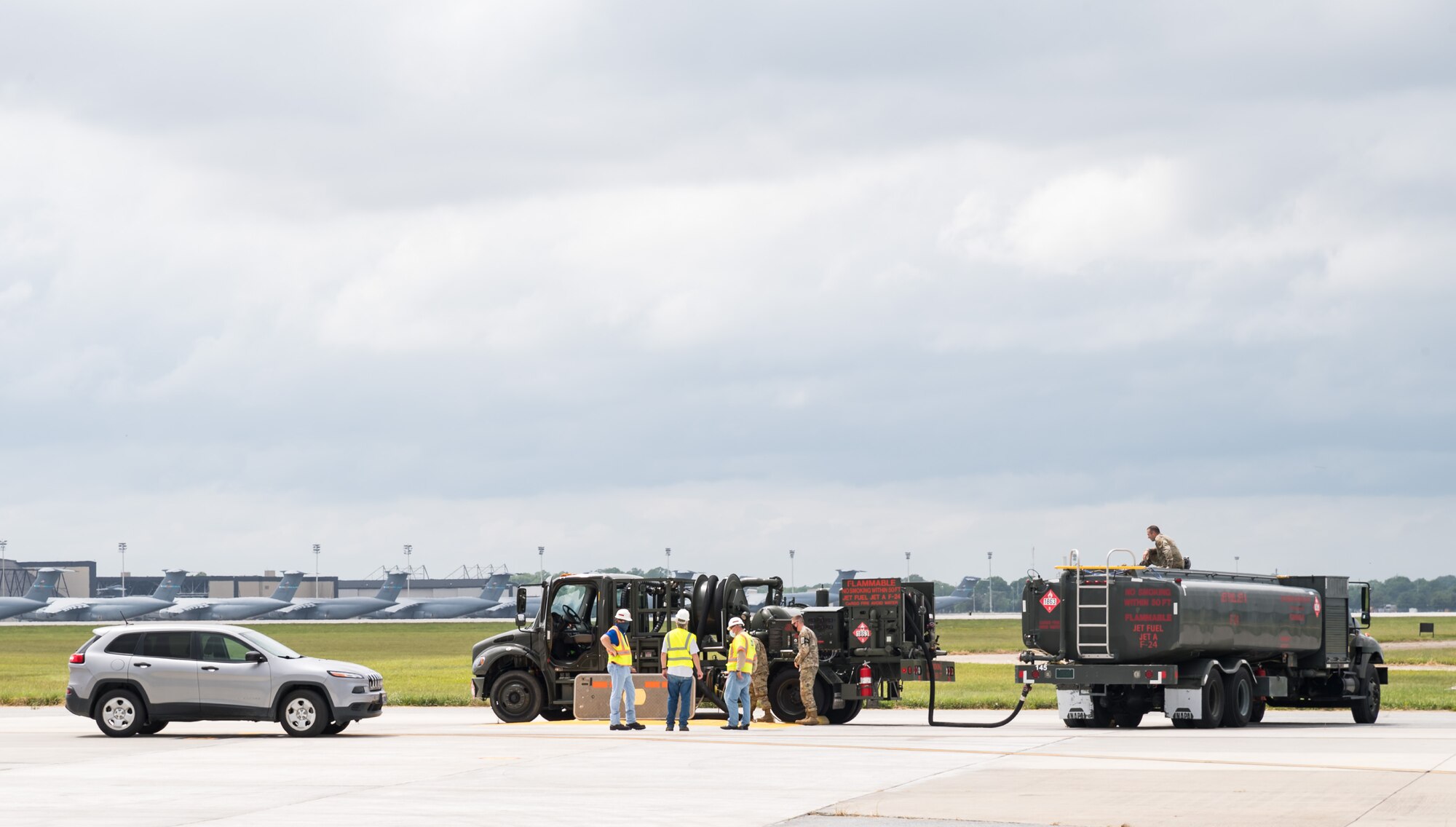 Hoses from an R-12 hydrant service vehicle are shown connected to one of three new fuel hydrant pits located at the aircraft hot cargo area May 28, 2020, on Dover Air Force Base, Delaware. During fuel hydrant system performance testing, the R-12 pumped fuel to an R-11 fuel truck that was used to simulate a receiver aircraft. (U.S. Air Force photo by Roland Balik)