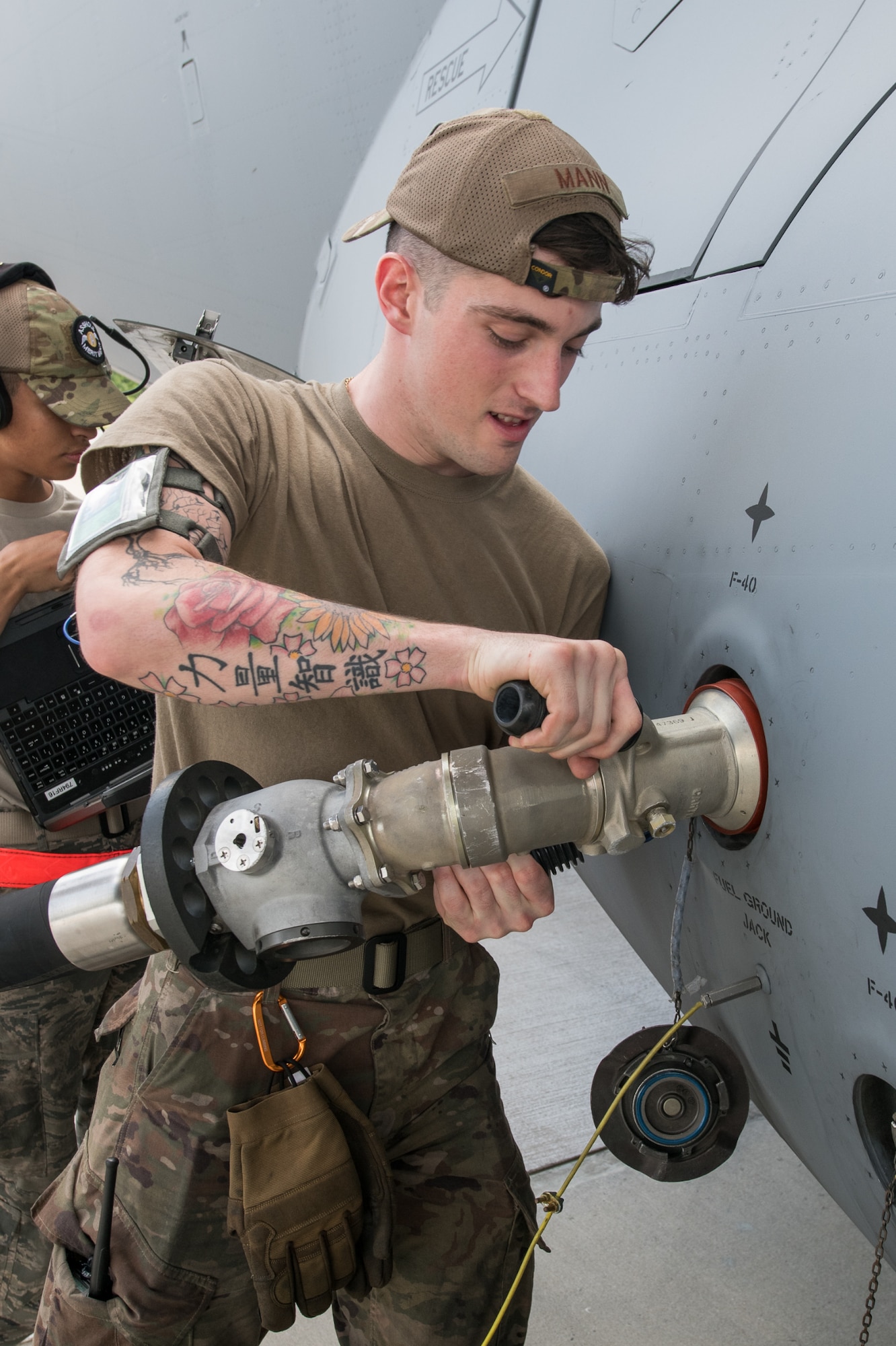Senior Airman William Mann, 736th Aircraft 
Maintenance Squadron C-17 Globemaster III crew chief, attaches a hose from an R-12 hydrant servicing vehicle to a C-17 Globemaster III during the testing of a brand-new Type III hydrant system May 29, 2020, at Dover Air Force Base, Delaware. The newly constructed fuels facility and pits will streamline the refueling process for aircraft at the hot cargo pad. (U.S. Air Force photo by Mauricio Campino)