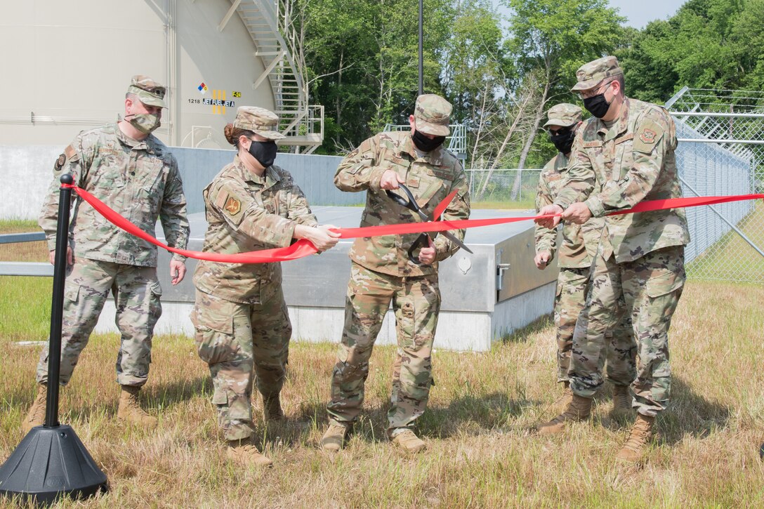 Col. Matthew Jones, 436th Airlift Wing commander, cuts a ribbon, marking the official opening of the brand-new hazardous cargo fuels facility June 4, 2020, on Dover Air Force Base, Delaware. The facility cuts response times to the hot cargo pad by 33 percent and refueling times by 50 percent. (U.S. Air Force photo by Airman 1st Class Stephani Barge)