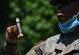 A U.S. Army Soldier holds up a mass rapid COVID-19 test sample during testing at Joint Base Langley-Eustis, Virginia, June 3, 2020. The pilot test for the oral swabs will help the Department of Defense evaluate the alternate method’s effectiveness, impact and mass testing capabilities. (U.S. Air Force photo by Senior Airman Monica Roybal)