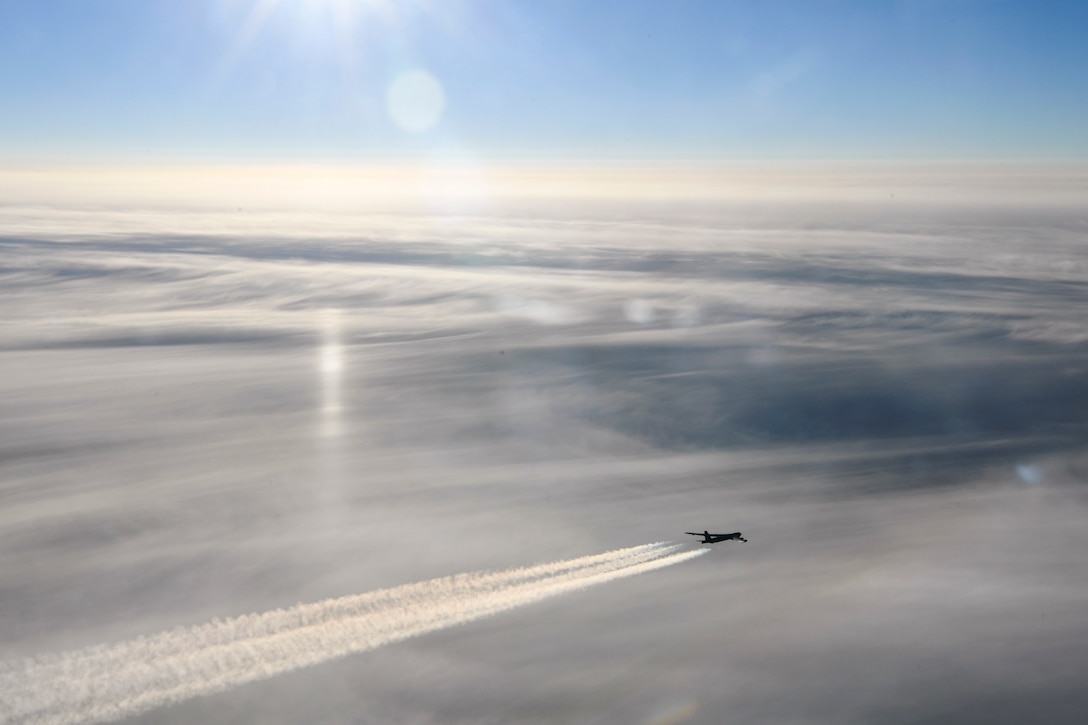 An aircraft flies over the arctic.
