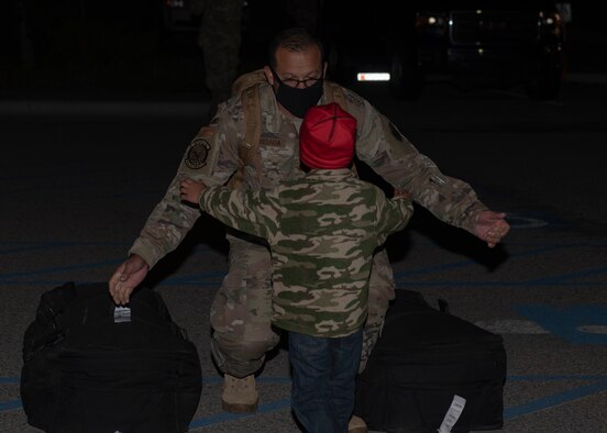 U.S. Air Force Maj. Jesus Burciaga, 726th Air Control Squadron director of operations, greets his son, May 21, 2020 at Mountain Home Air Force Base, Idaho. The 726th Air Control Squadron returned from an eight month long deployment that was extended due to the COVID-19 pandemic. (U.S. Air Force photo by Airman 1st Class Natalie Rubenak)