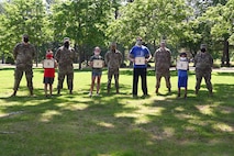 Members of the First Sergeants Council stand behind winners of the 31-day run, walk challenge at Hanscom Air Force Base, June 4. The event took place throughout the month of May, and the 40 participants logged over 3,000 miles. (U.S. Air Force Photo by Todd Maki)