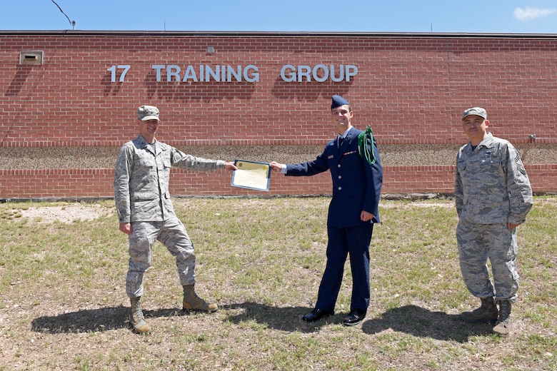 U.S. Air Force Col. Thomas Coakley, 17th Training Group commander, presents the 312th Training Squadron Student of the Month award to Airman Jacob Warren, 312th TRS student, at Brandenburg Hall on Goodfellow Air Force Base, Texas, June 5, 2020. The 312th TRS’ mission is to provide Department of Defense and international allies with mission ready fire protection and special instruments graduates and provide mission support for the Air Force Technical Applications Center. (U.S. Air Force photo by Senior Airman Zachary Chapman)