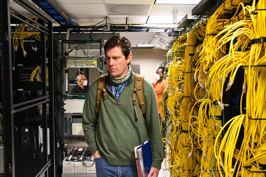 man walks through a server room