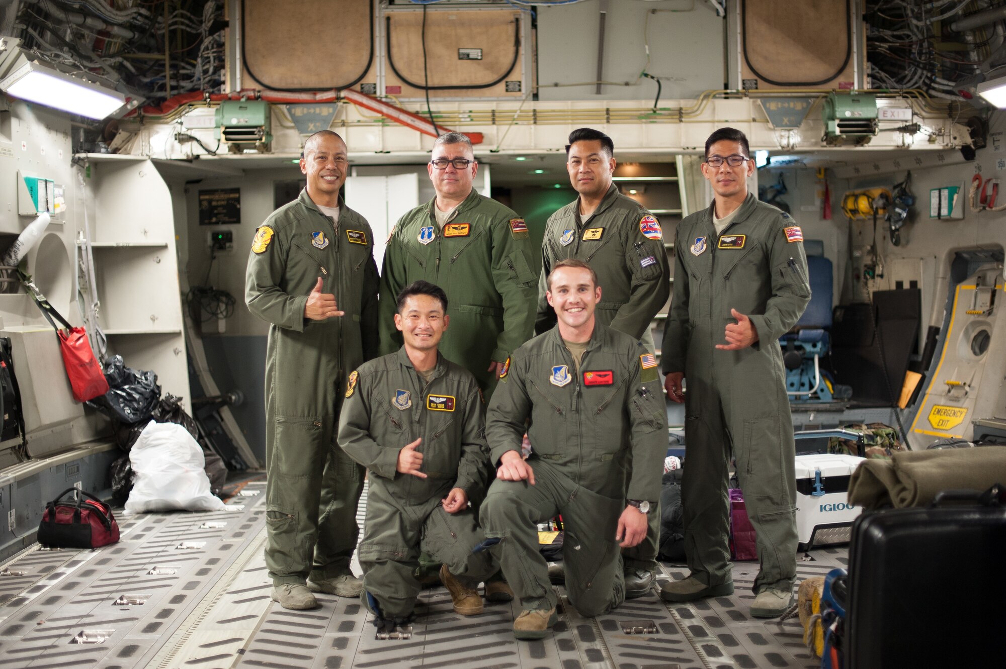 204th Airlift Squadron Airmen, Master Sgt. Brandon Sarceda, Senior Master Sgt. Kale Barney, Maj. Kalei Ho’opai, Capt. Justin Sato, Tech. Sgt. Sean Chang, and a member of the 535th AS, 1st Lt. Andrew Lightsinn, celebrate their arrival at Joint Base Pearl Harbor-Hickam, Hawaii, March 31, after completing a 41-hour aeromedical-evacuation mission.