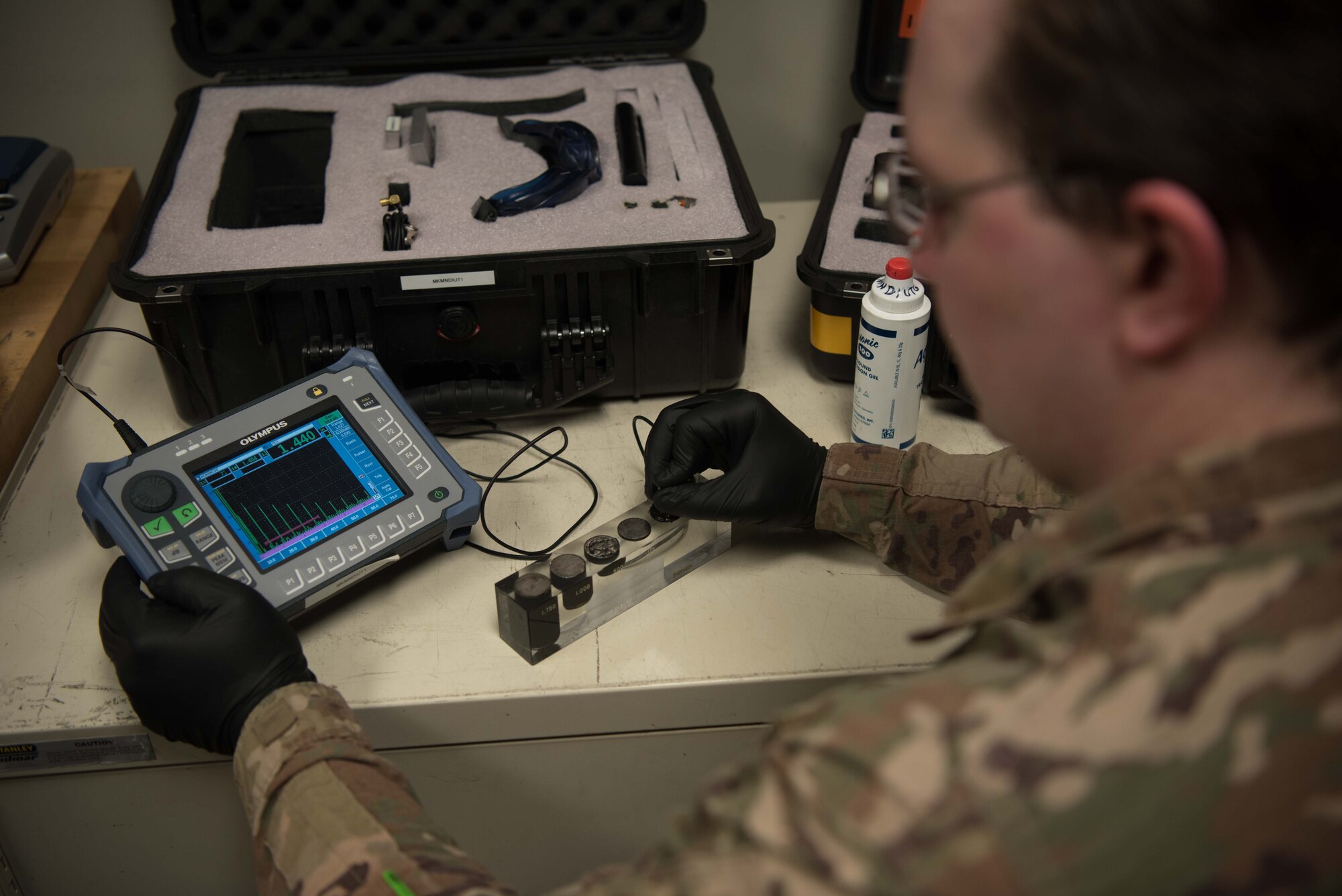 Staff Sgt. Benjamin Reeves, 22nd Maintenance Squadron nondestructive inspection craftsman, uses a Sonic 1200 ultrasonic flaw detector to measure the aluminum thickness standard May 28, 2020, at McConnell Air Force Base, Kansas. The NDI flight uses the equipment that emits ultrasounds to determine a part’s thickness and to identify subsurface cracks measuring 0.005 inches. (U.S. Air Force photo by Senior Airman Alexi Bosarge)