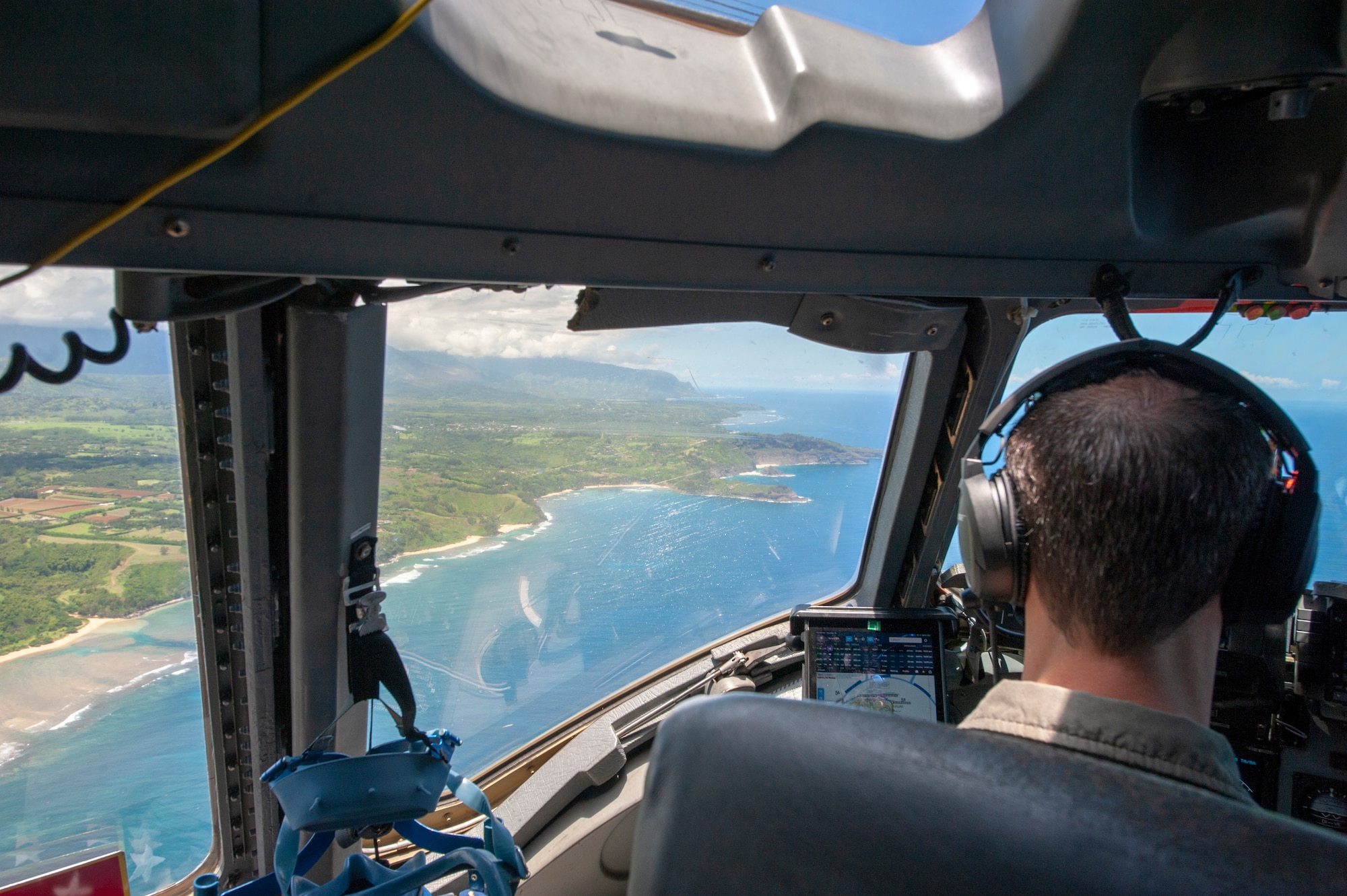 Lt. Col. Chris Skoutas, 535th Airlift Squadron pilot flies a C-17 Globemaster III off the coast of Kauai Island, Hawaii May 14, 2020.
