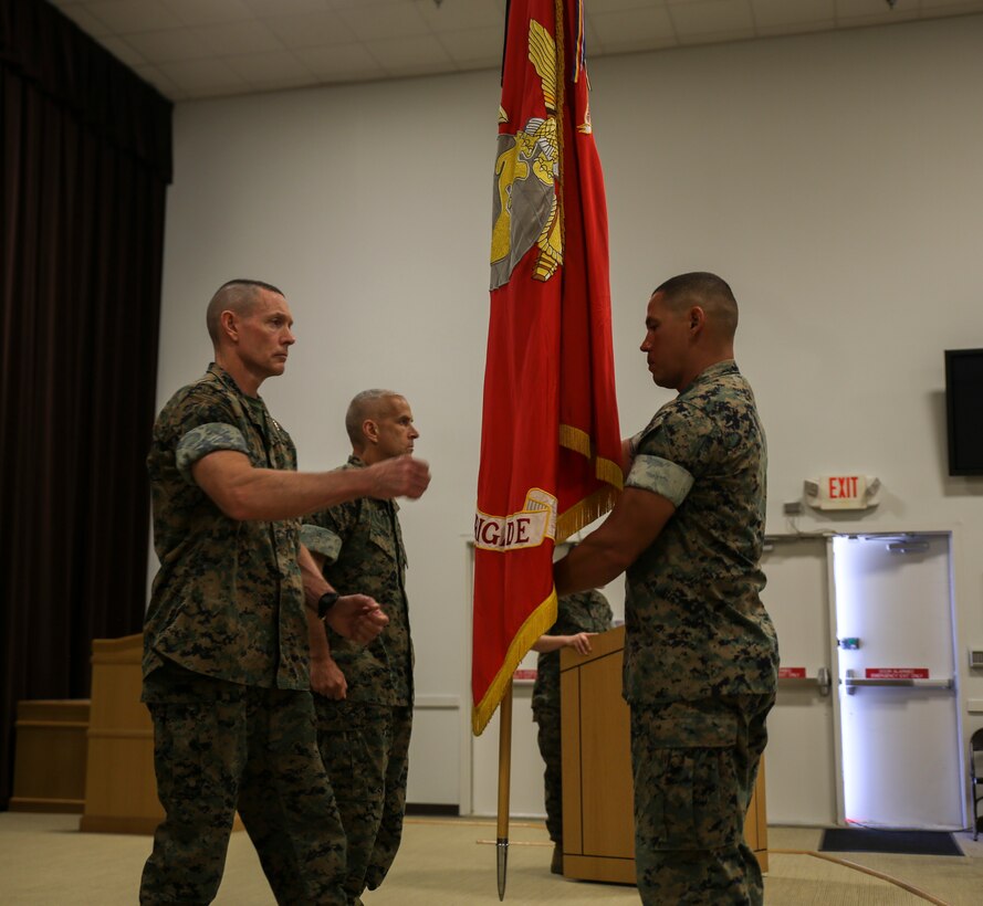 U.S. Marine Corps Sgt. Maj. Don J. Hernandez, II Marine Expeditionary Force Support Battalion sergeant major, prepares to hand the colors to Maj. Gen. Stephen M. Neary, commanding general 2nd Marine Expeditionary Brigade, during a change of command ceremony at Camp Lejeune, N.C., June 5, 2020. Neary will be the commanding general of U.S. Marine Forces Europe and Africa. (U.S. Marine Corps photo by Lance Cpl. Samuel Lyden)