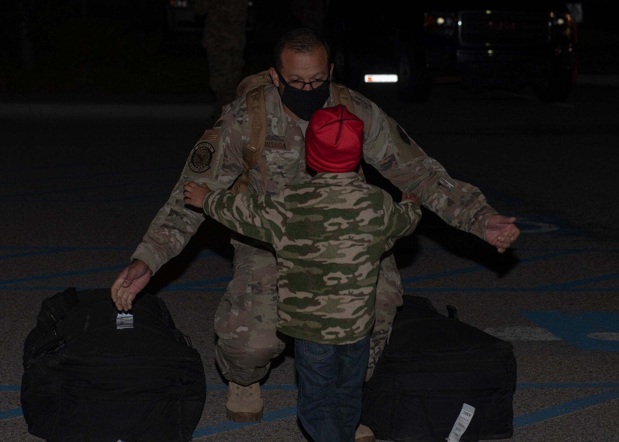 U.S. Air Force Maj. Jesus Burciaga, 726th Air Control Squadron director of operations, greets his son, May 21, 2020 at Mountain Home Air Force Base, Idaho. The 726th Air Control Squadron returned from an eight month long deployment that was extended due to the COVID-19 pandemic. (U.S. Air Force photo by Airman 1st Class Natalie Rubenak)