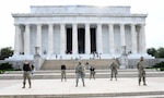 Airmen from the 113th Wing, D.C. Air National Guard, stand on the national mall on June 4, 2020. Airmen from the 113th Wing performed lifesaving CPR on a jogger at the Lincoln Memorial June 4.