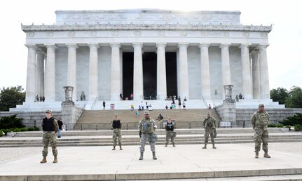 Airmen from the 113th Wing, D.C. Air National Guard, stand on the national mall on June 4, 2020. Airmen from the 113th Wing performed lifesaving CPR on a jogger at the Lincoln Memorial June 4.