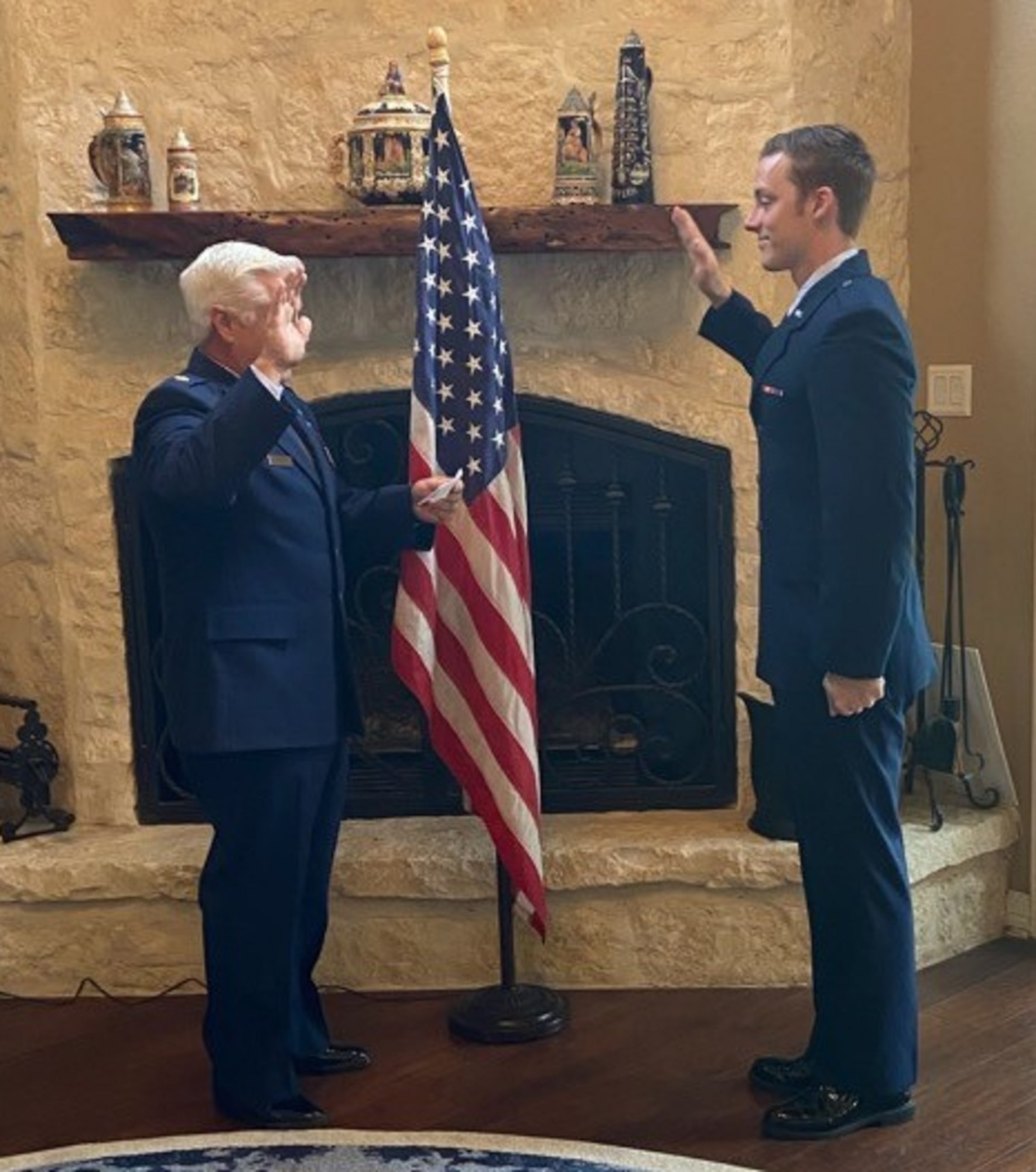 Retired Air Force Maj. Glenn Taylor, left, commissions his son Jordan into the United States Air Force May 22, 2020. The event marked the third child the elder Taylor, lead cyber analyst for OSI 3rd Field Investigations Squadron, Joint Base San Antonio-Lackland, Texas, has commissioned into the USAF. (Photo courtesy 3 FIS)