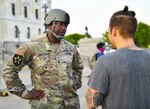 Minnesota National Guard Master Sgt. Acie Matthews Jr. peacefully engages with protesters to show solidarity and request compliance with the state curfew at the grounds of the Minnesota state capitol in St. Paul, June 1, 2020.