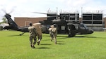 Members of the Louisiana National Guard load 50,000 masks and 2,000 gloves aboard two UH-60 Black Hawk helicopters in Baton Rouge June 6, 2020, ahead of Tropical Storm Cristobal, for use if search-and-rescue missions are necessary.