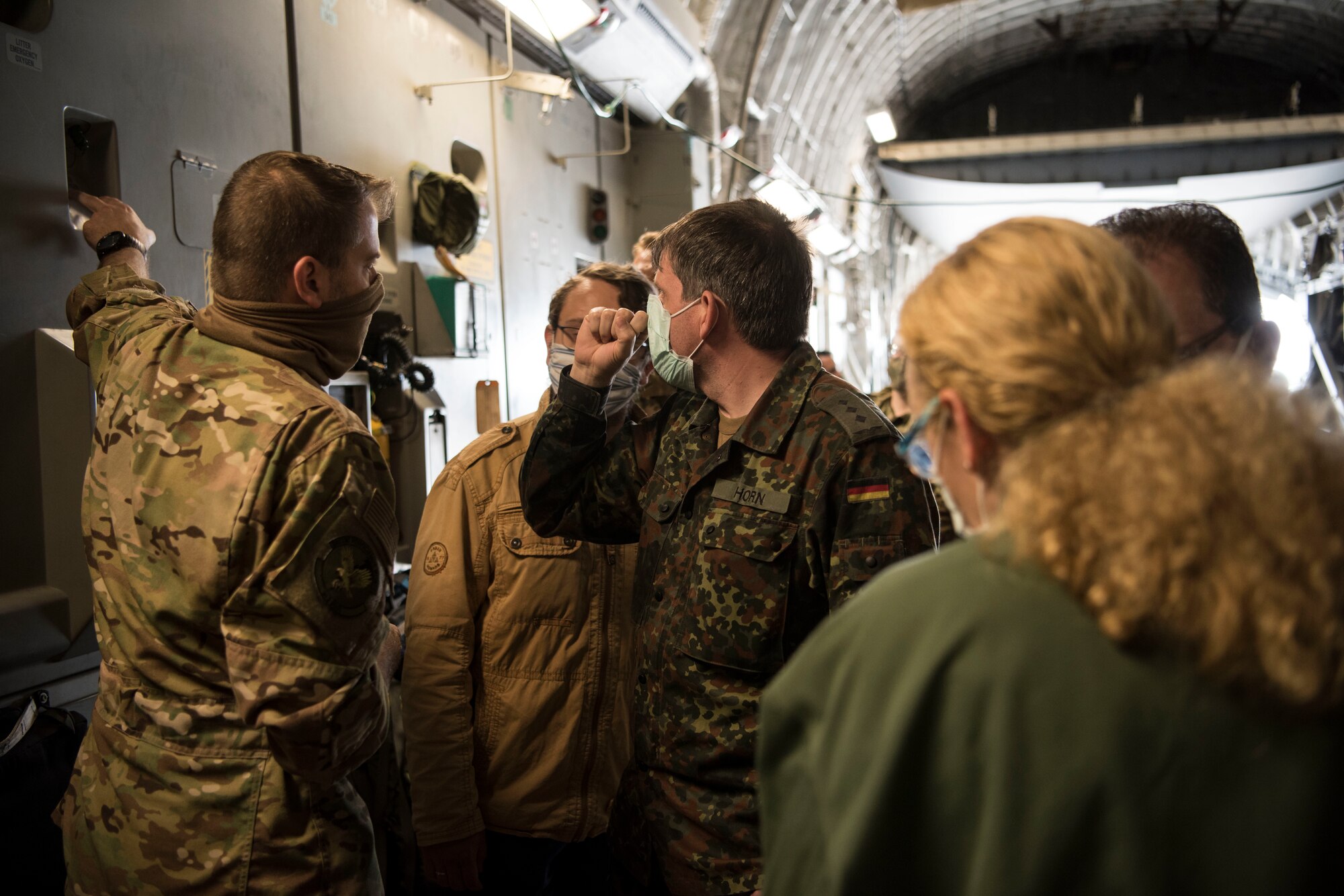 U.S. Air Force Maj. Sean Smith, 10th Expeditionary Aeromedical Evacuation Flight aeromedical evacuation operations team officer in charge, explains the layout of a U.S. Air Force C-17 Globemaster III aircraft.