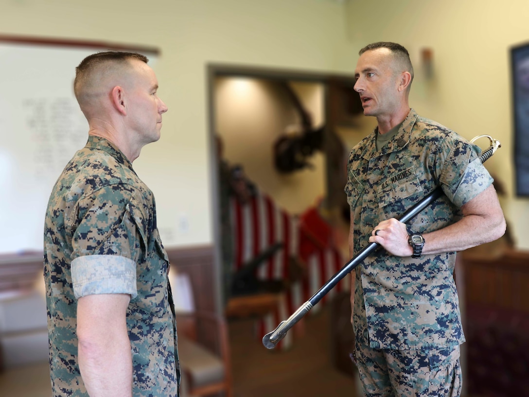 U.S. Marine Corps Sgt.Maj. Christopher Adams (right), the outgoing Sergeant Major of U.S. Marine Corps Security Force Regiment (MCSFR), Fleet Marine Force Atlantic, U.S. Marine Corps Forces Command, reports to Col. Corey M. Collier, the commanding officer of MCSFR, during a relief and appointment ceremony June 3, 2020 at Naval Weapons Station Yorktown, Virginia. The ceremony was conducted virtually, as part of MCSFR’s COVID-19 response measures, and signifies the passing of responsibilities from Sgt.Maj. Christopher Adams to Sgt.Maj. Christopher J. Easter as the Regimental Sergeant Major for MCSFR. (U.S. Marine Corps photo illustration by Staff Sgt. Jessika Braden/ Released)